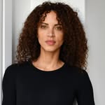 A photo of Noémie Lenoir, a Model, who has a Soft Autumn color profile.