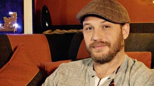 A photo of Tom Hardy, a Actor, who has a Soft Autumn color profile.