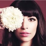 A photo of Hannah Simone, a Actress, Podcaster, who has a Dark Winter color profile.