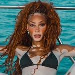 A photo of Winnie Harlow, a Model, Activist, who has a Dark Autumn color profile.